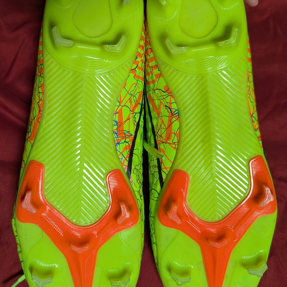 Vibrant Green and Orange Soccer Cleats